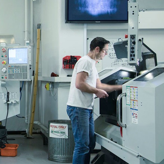 Man in strength of materials lab doing testing